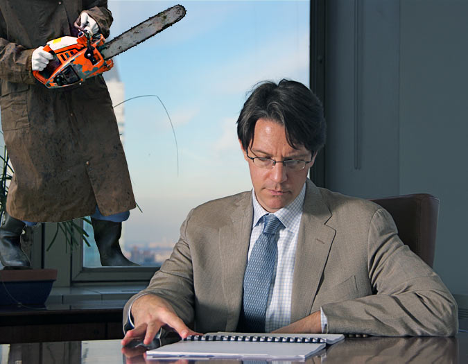 Man sitting at desk in noisy office with chainsaw nearby